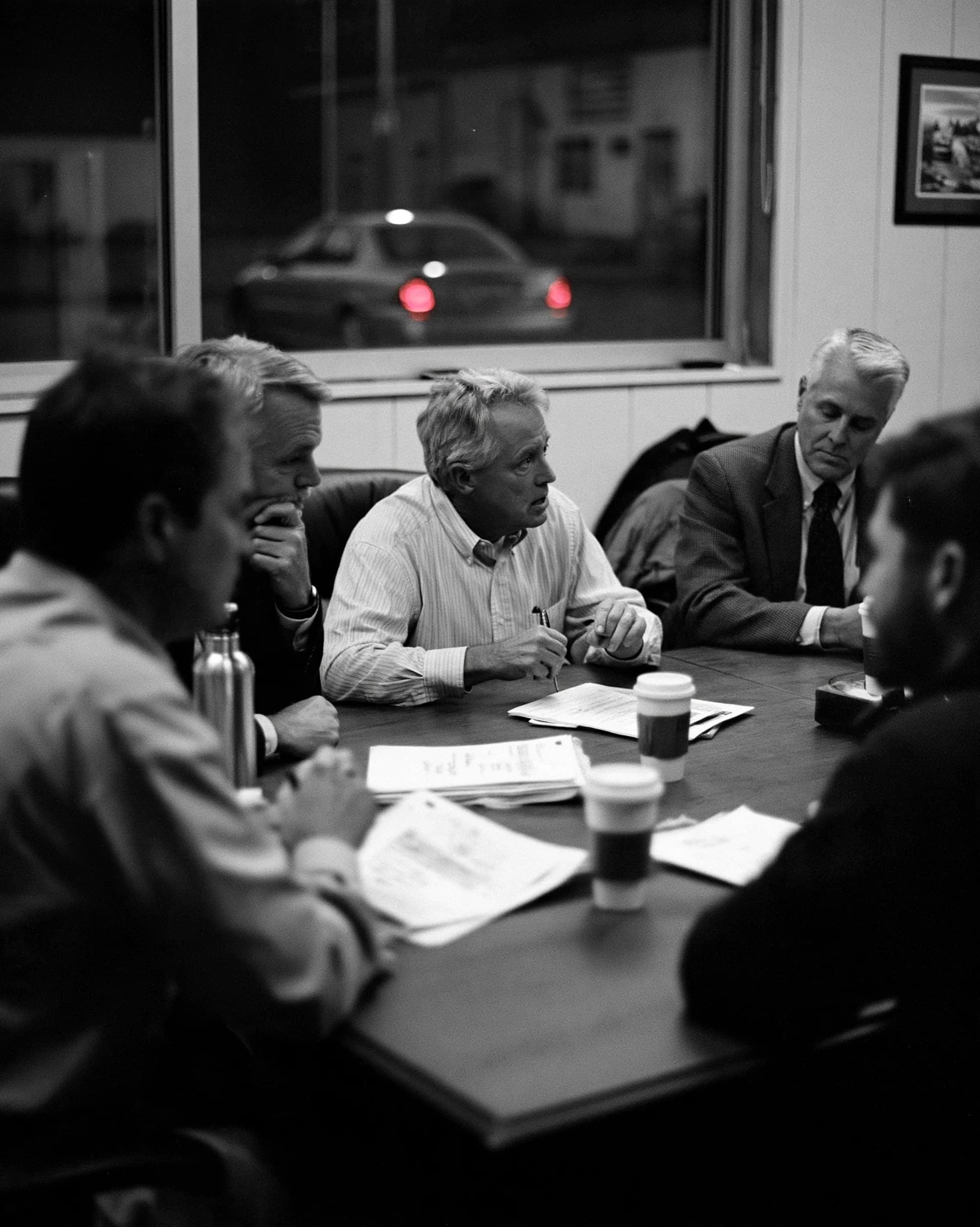 A business owner and their attorney across the table from a buyer late in a negotiation